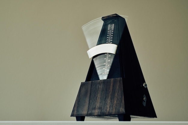 Vintage metronome on a black background