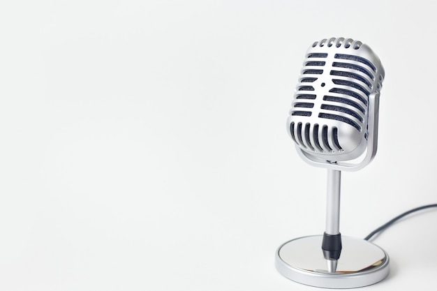 The vintage microphone close up image on white background.