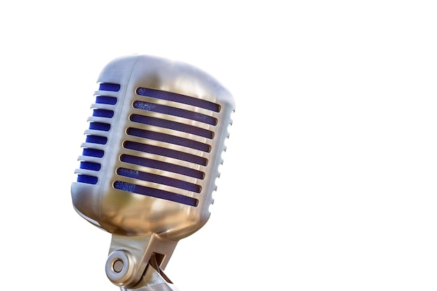 Vintage microphone, metallic retro style with white surface and copyspace.