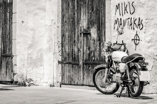 Vintage motorcycle parked near concrete wall