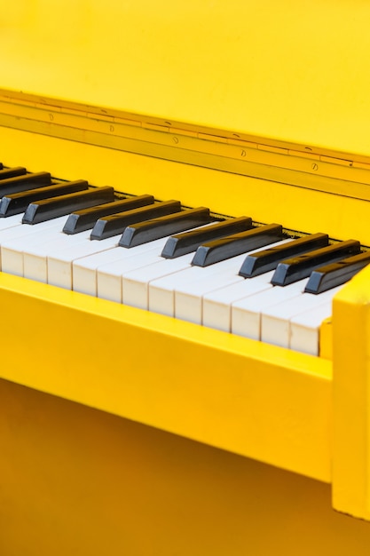 Vintage musical instrument yellow piano close up