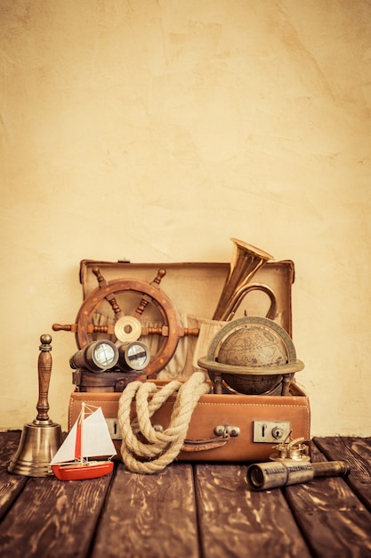 Vintage nautical items in suitcase Travel and summer vacation concept