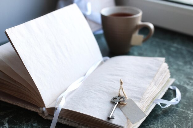 Vintage notebook on green marble windowsill opened with blank pages and a bunch of lavender