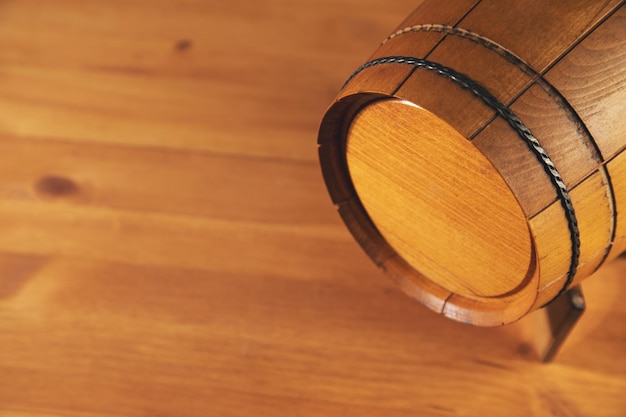 Vintage oak barrel on a wooden table background