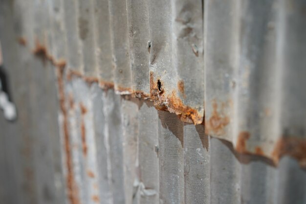 Vintage and old rustic zinc sheet outdoor wall beside the street Bangkok Thailand.