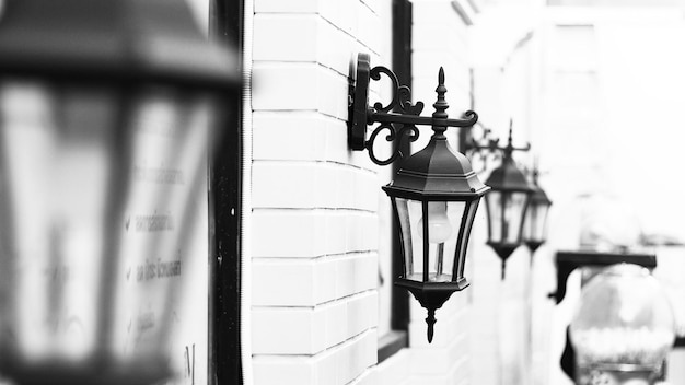 Vintage Old Street Classic Iron Lantern on the House Wall, Close Up in black and white