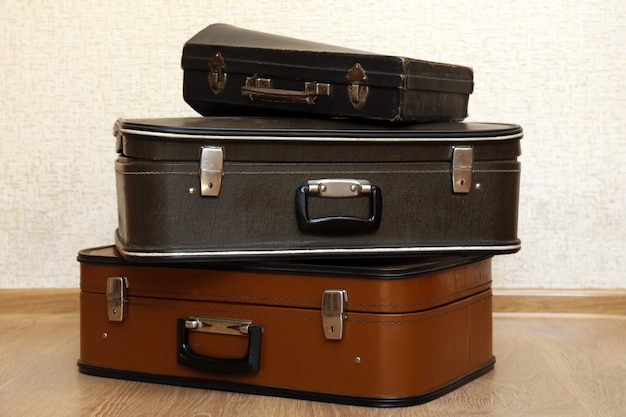 Vintage old travel suitcases on floor