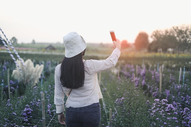 Foto d'epoca di una giovane donna rilassante nel giardino fiorito.