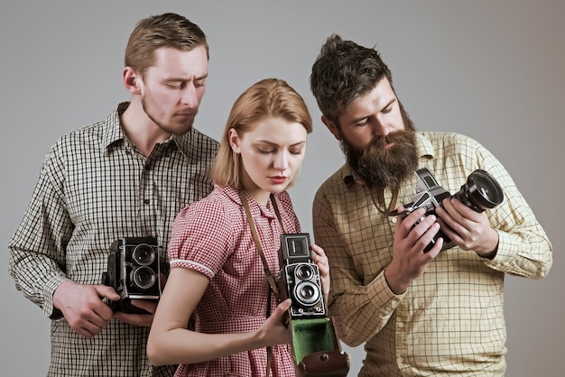 Vintage photography concept company of retro photographers with old cameras filming