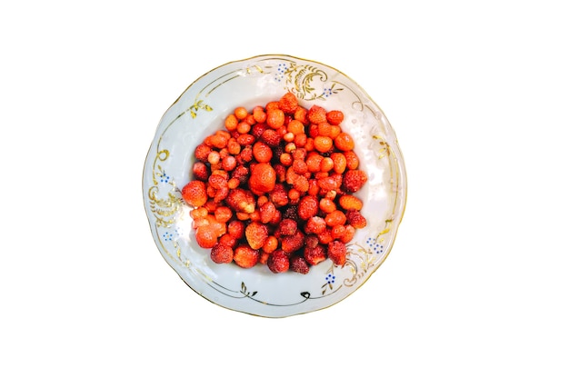 Vintage plate with home strawberries isolated on white background. Healthy vegetarian ecological food lifestyle concept.