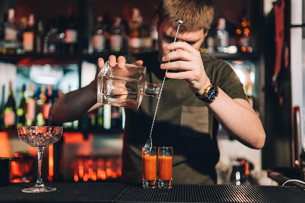 Vintage portrait of bartender creating cocktails at bar Close up of alcoholic beverage preparation