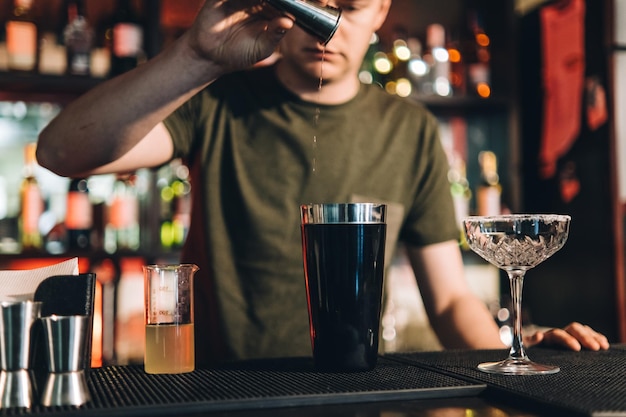 Vintage portrait of bartender creating cocktails at bar Close up of alcoholic beverage preparation