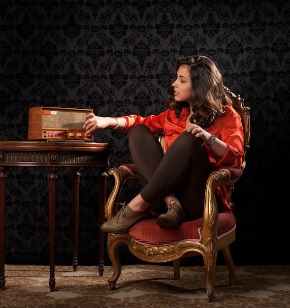 vintage portrait of a beautiful young woman tuning in