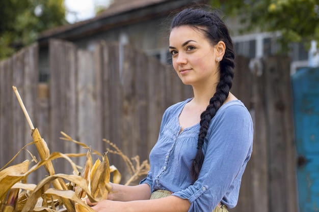 Vintage portrait of a sexy girl with corn concept of rural harvesting