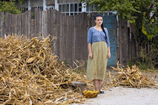 Vintage portrait of a sexy girl with corn, concept of rural harvesting