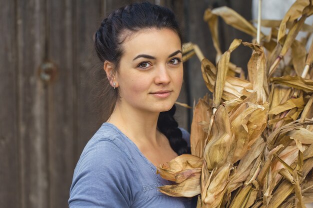 Vintage portrait of a sexy girl with corn, concept of rural harvesting