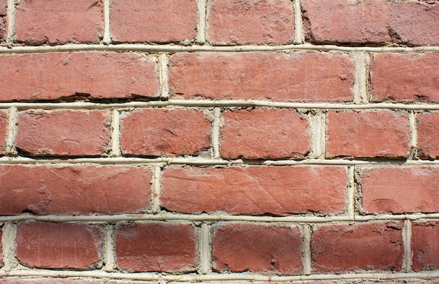 Vintage red brick wallDilapidated brick wallbackgroundtexture Faded ancient brick building
