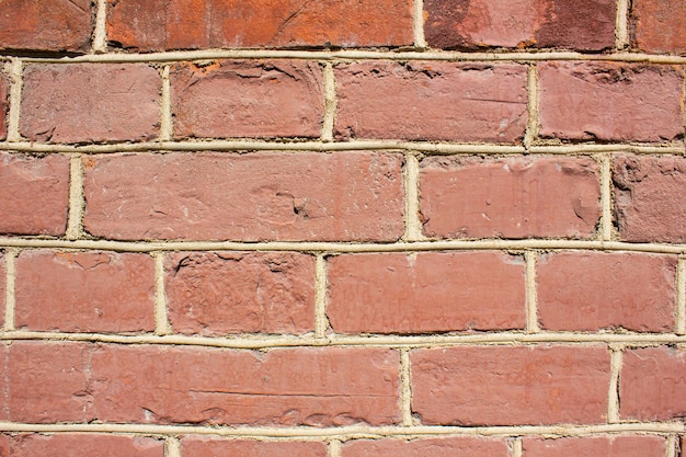 Vintage red brick wallDilapidated brick wallbackgroundtexture Faded ancient brick building