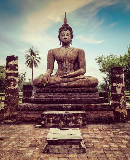 Vintage retro effect filtered hipster style travel image of Buddha statue hand close up detail Sukhothai Thailand