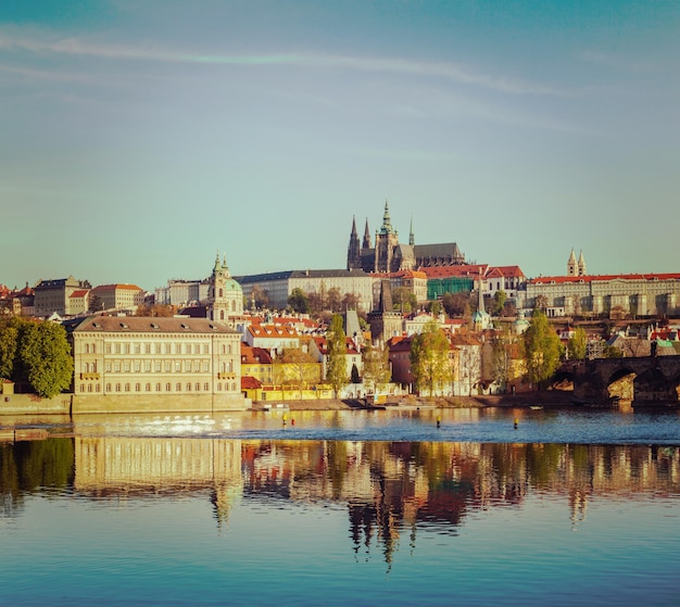 Vintage retro hipster style travel image of Mala Strana and Prague castle over Vltava river 프라하 체코 공화국