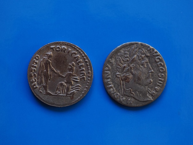 Vintage Roman coin over blue