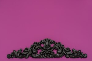 vintage royal silver horizontal background with black ornaments on a pink wall