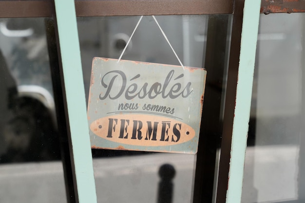 Photo vintage shop sign desoles nous sommes fermes in french text means english shop sorry we are closed