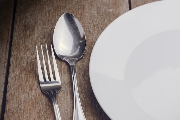 Vintage silverware on rustic wooden background