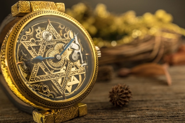 Vintage skeleton watch with Star of David on wood background