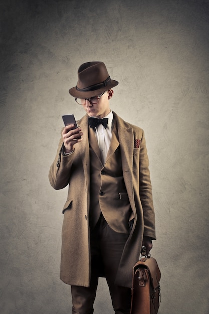 Vintage style elegant man with a smartphone