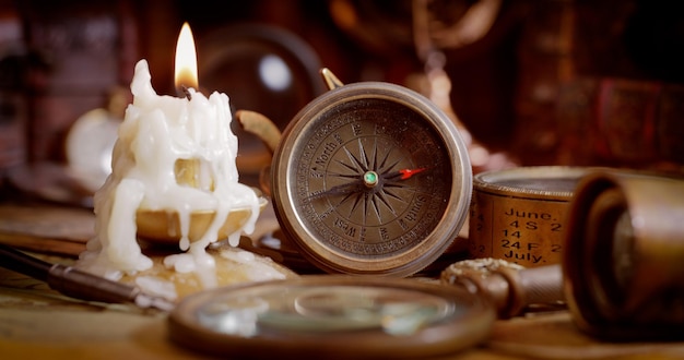 Vintage style travel and adventure Vintage old compass and other vintage items on the table