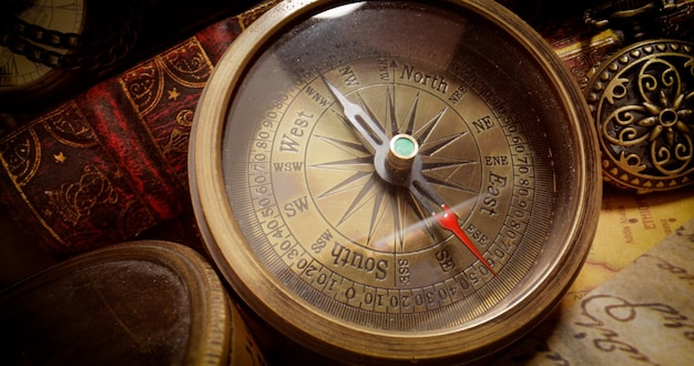 Vintage style travel and adventure Vintage old compass and other vintage items on the table