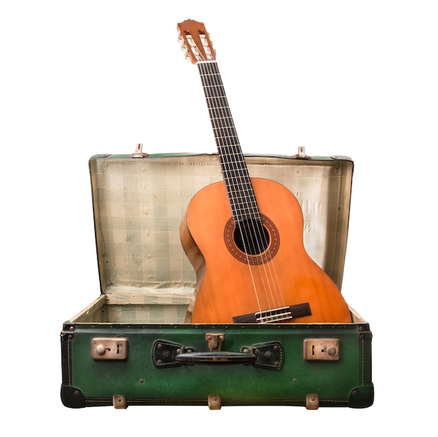 Vintage suitcase on white background with guitar