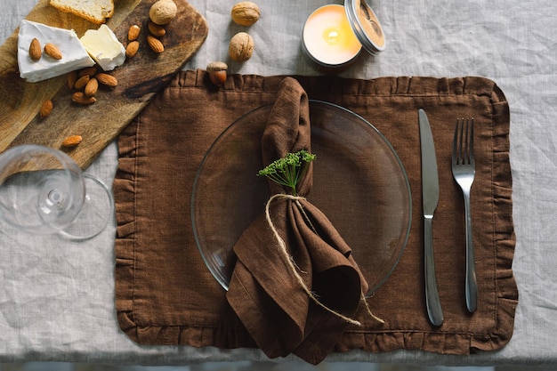 Vintage table setting with Linen napkins and floral decorations Close up Cozy calm meal in the morning in the sunshine