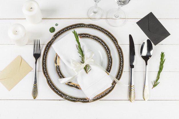 Vintage table setting on wooden table with floral decor