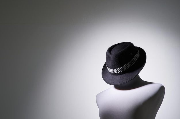 Vintage tailor's mannequin with hat isolated on white
