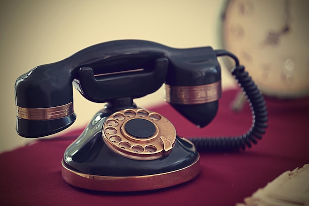 Vintage telephone on red table