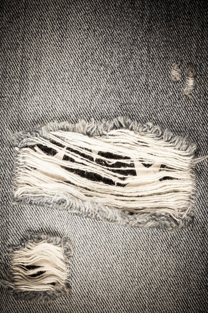 Vintage torn denim jeans texture.