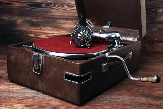 Vintage turntable vinyl record player on wooden background