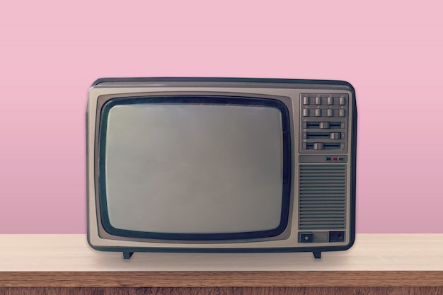 Vintage TV box on wooden table and pink pastel color background.