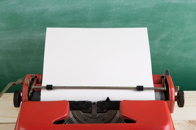 Vintage typewriter on the table with blank paper concept for writing journalism blogging