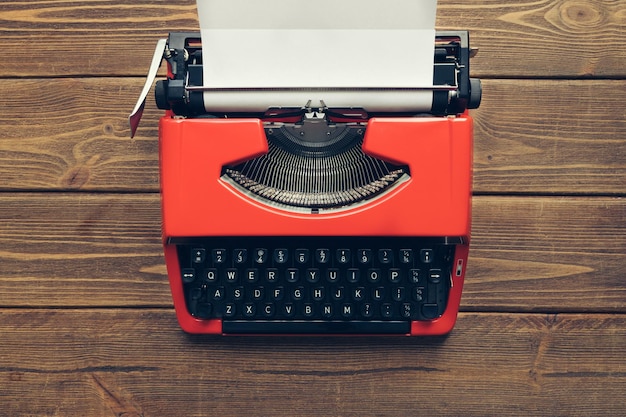 Vintage typewriter on wooden background