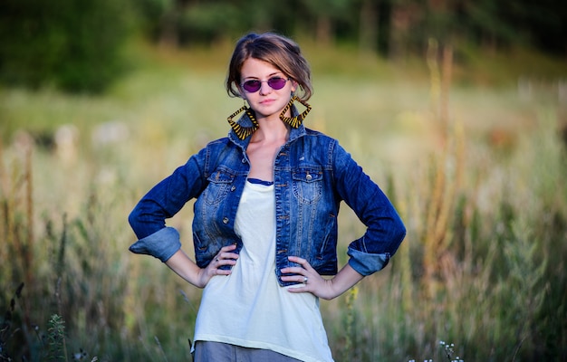 Vintage way dressed yang beautiful woman walks outdoor in summer time.