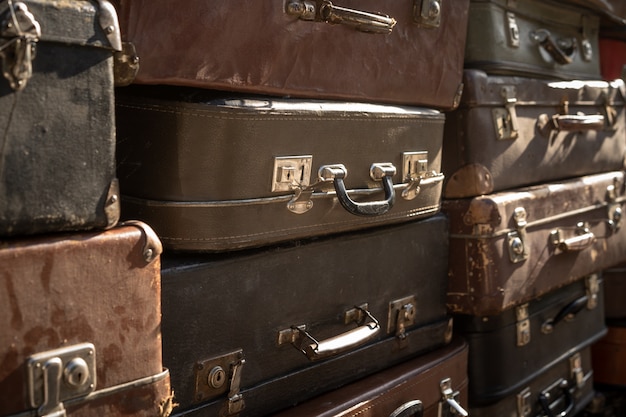 Vintage weathered leather suitcases on top of eachother