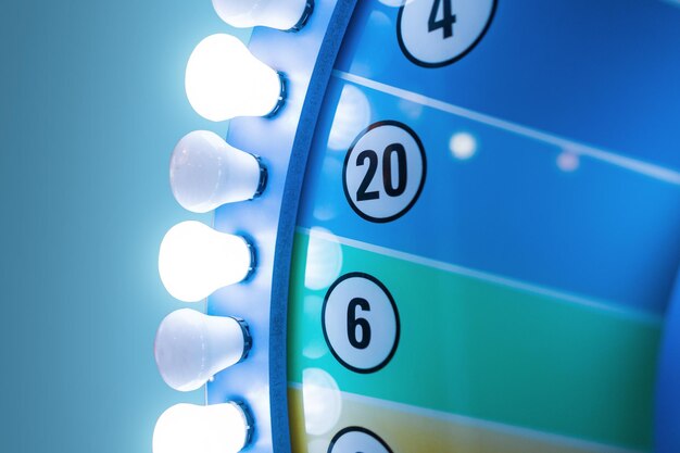 Vintage wheel fortune with light bulbs on blue background. luck\
and lottery