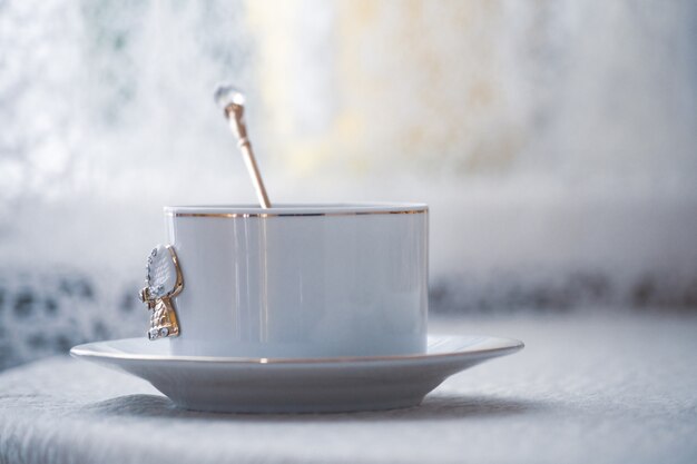 Vintage white cup on table in natural light