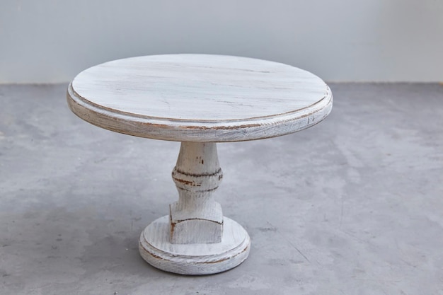 Vintage white empty wooden cake stand close-up