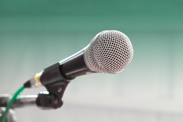 Vintage wired microphone with green background