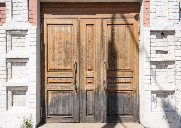 Vintage wooden wide door to a 19th century building