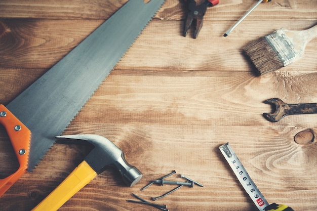 Vintage working tools on wooden background